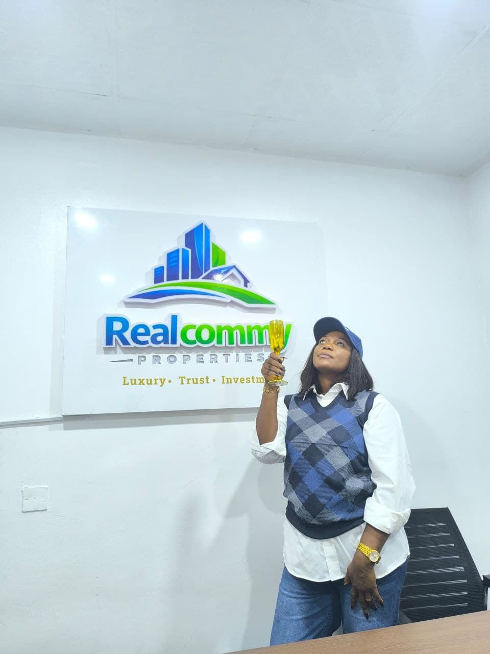 RealCommy Properties office reception with the company logo wall